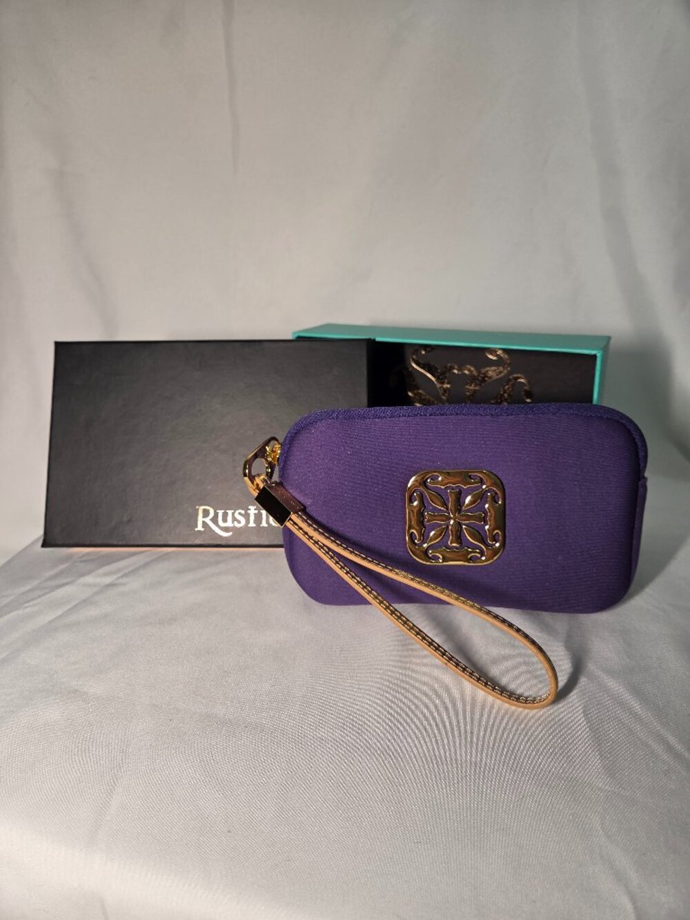 Rustic Cuff wristlet. New in box. Purple neoprene with gold strap, gold hardware
